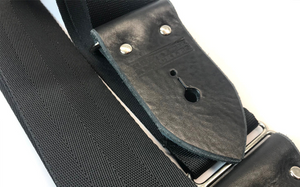 Black Guitar Strap Made From Seat Belt Material With Leather Ends